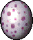An oval, white egg. It has red polkadots of different sizes covering it's shell.